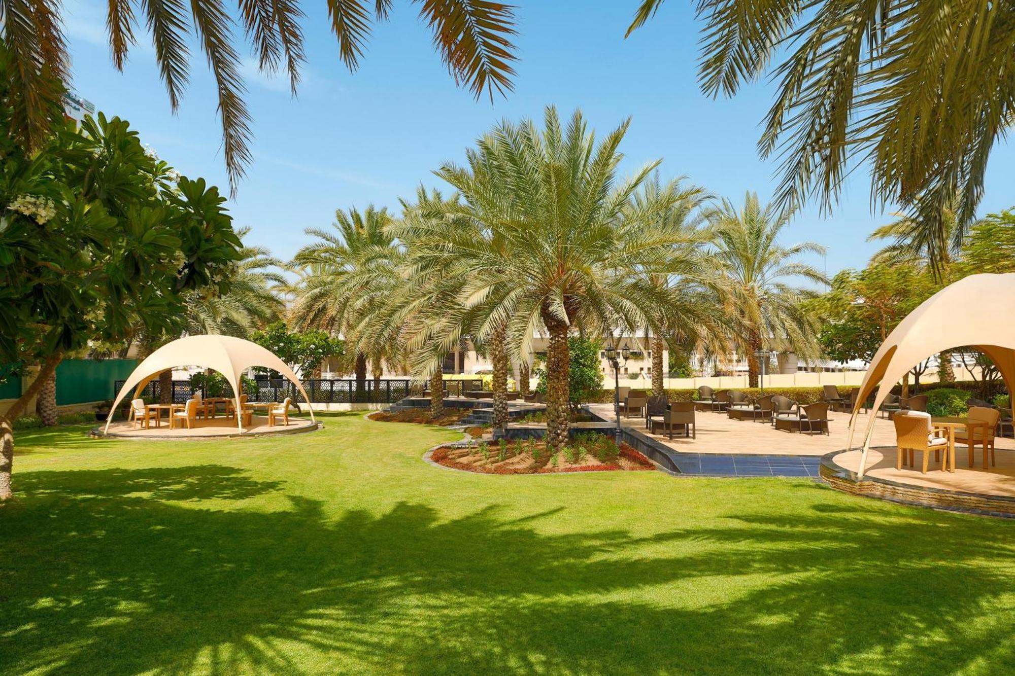 Sheraton Oman Hotel Маскат Экстерьер фото The resort's gardens